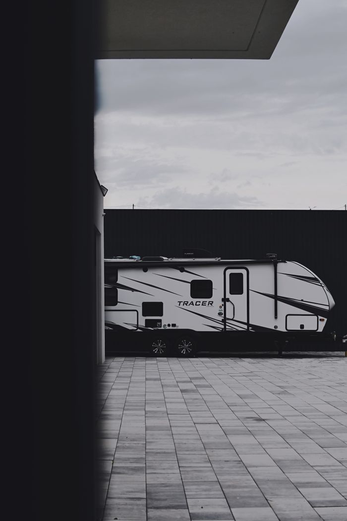 services-02 Sleek Tracer caravan parked outdoors on a tiled surface, emphasizing modern travel lifestyle.